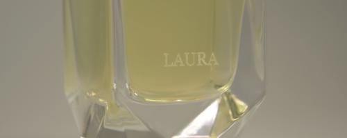 Laser glass engraving of a name on a perfume bottle for elegant personalization